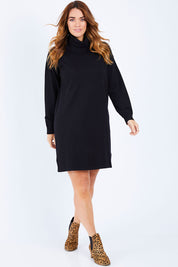 Model Laura wearing size L of The Roll Neck Tunic Dress in colour Black (Black), from the front, showing the whole outfit