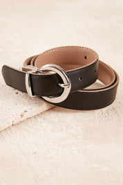 A model wearing The Bella Genuine Reversible Leather Belt in colour Black (Black), from the front, showing the whole outfit