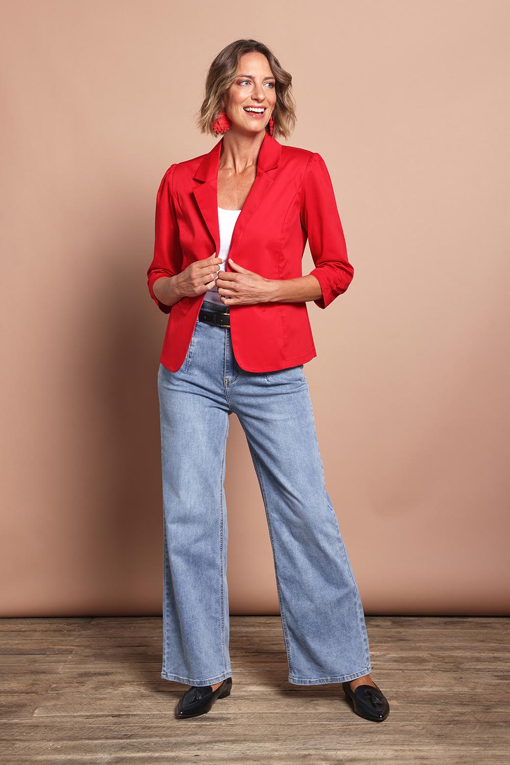 Model Riina wearing size 10 of The Everyday Blazer in colour Firered (Red), from the front, showing the whole outfit