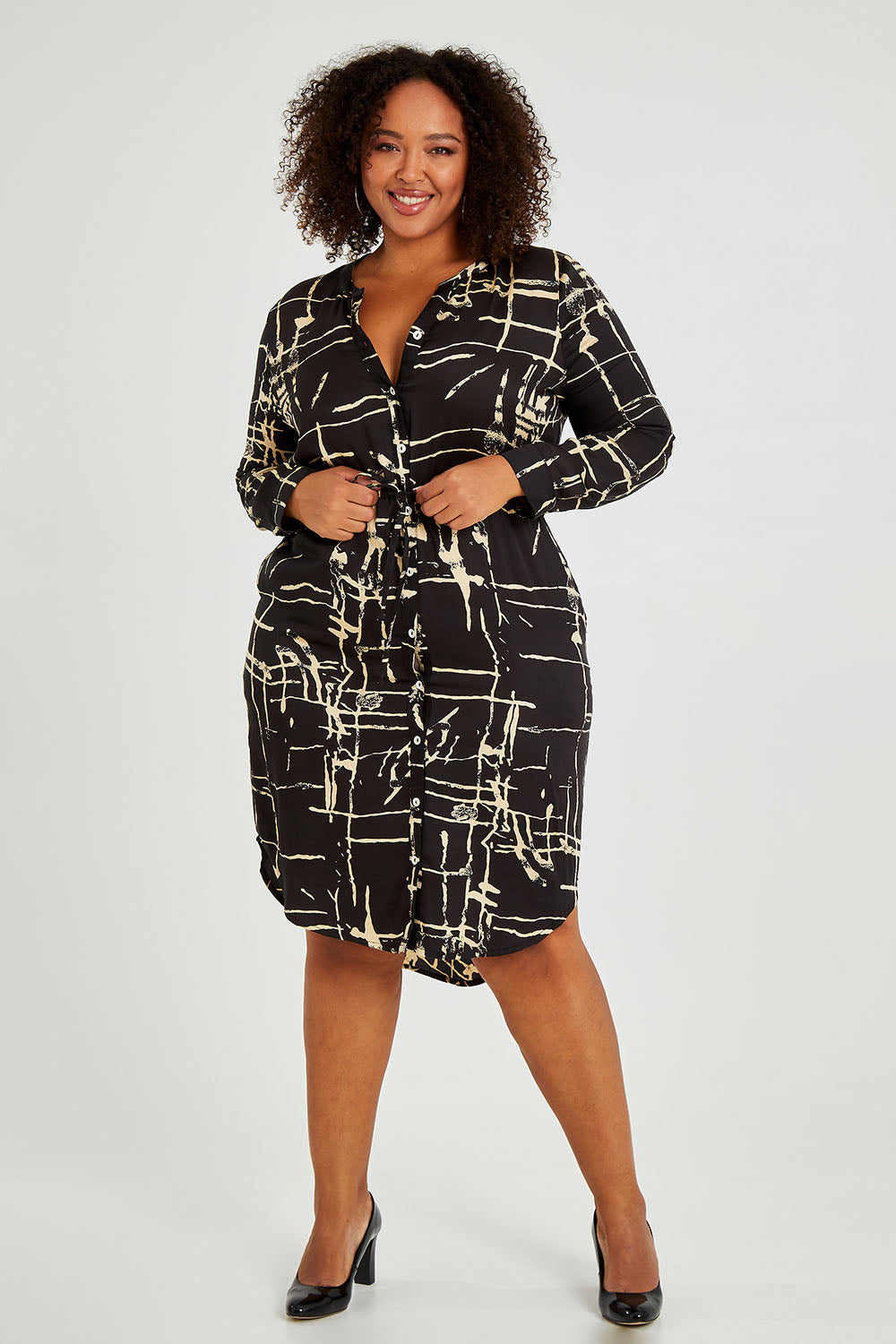 Model Alexis wearing size 16 of The Luxe Viscose Drawstring Dress in colour Sketch (Black), from the front, showing the whole outfit