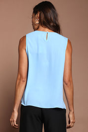 Model Amanda wearing size 10 of The Asymmetrical Tank Top in colour Sky (Blue), from the back