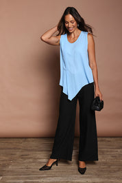 Model Amanda wearing size 10 of The Asymmetrical Tank Top in colour Sky (Blue), from the front, showing the whole outfit