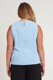 Model Chanel wearing size 16 of The Asymmetrical Tank Top in colour Sky (Blue), from the back