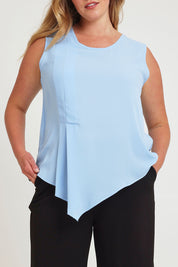 Model Chanel wearing size 16 of The Asymmetrical Tank Top in colour Sky (Blue), from the front, cropped image