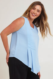 Model Chanel wearing size 16 of The Asymmetrical Tank Top in colour Sky (Blue), from the front, cropped image