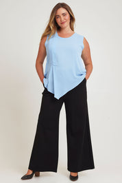 Model Chanel wearing size 16 of The Asymmetrical Tank Top in colour Sky (Blue), from the front, showing the whole outfit