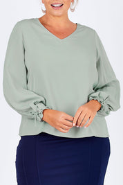 Model Fiona wearing size 16 of The Pleated Sleeve Top in colour Sage (Green), from the front, cropped image