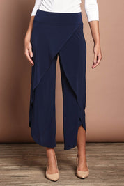 Model Madeline wearing size 10 of The Cross Over Pant in colour Navy (Blue), from the front, cropped image