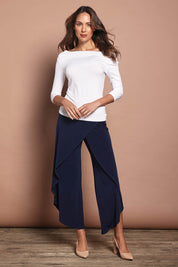 Model Madeline wearing size 10 of The Cross Over Pant in colour Navy (Blue), from the front, showing the whole outfit