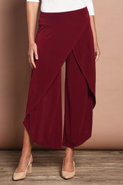 Model Madeline wearing size 10 of The Cross Over Pant in colour Port (Purple), from the front, cropped image