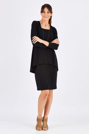 Model Monique wearing size 10 of The Long Rita Dress in colour Black (Black), from the front, showing the whole outfit
