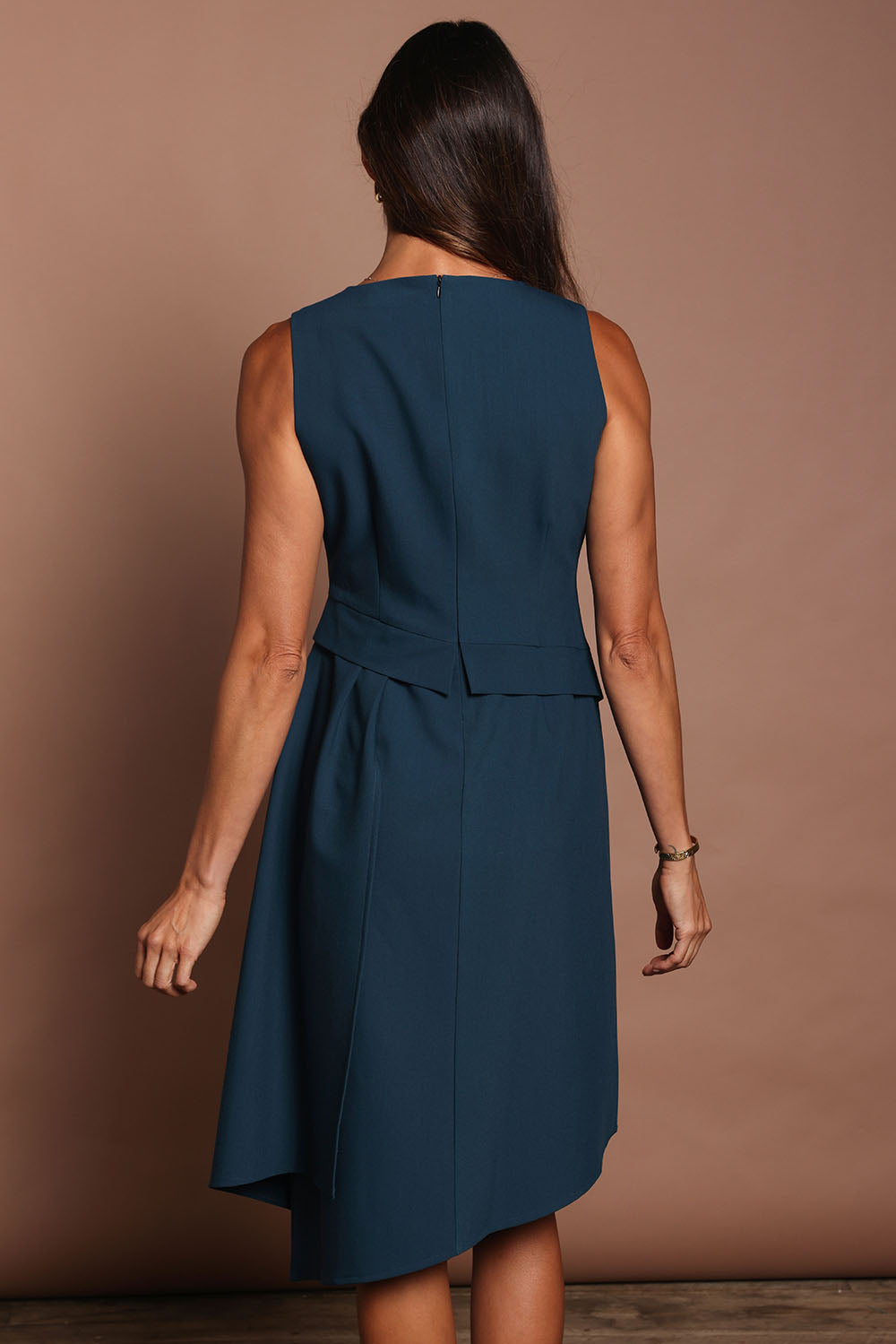 Model Amanda wearing size 10 of The Side Pleated Dress in colour Deepocean (Blue), from the back