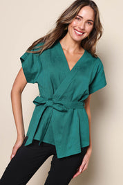 Model Madelinec wearing size 10 of the The Linen Tencel Kimono Top - Emerald in colour Emerald, in a cropped view