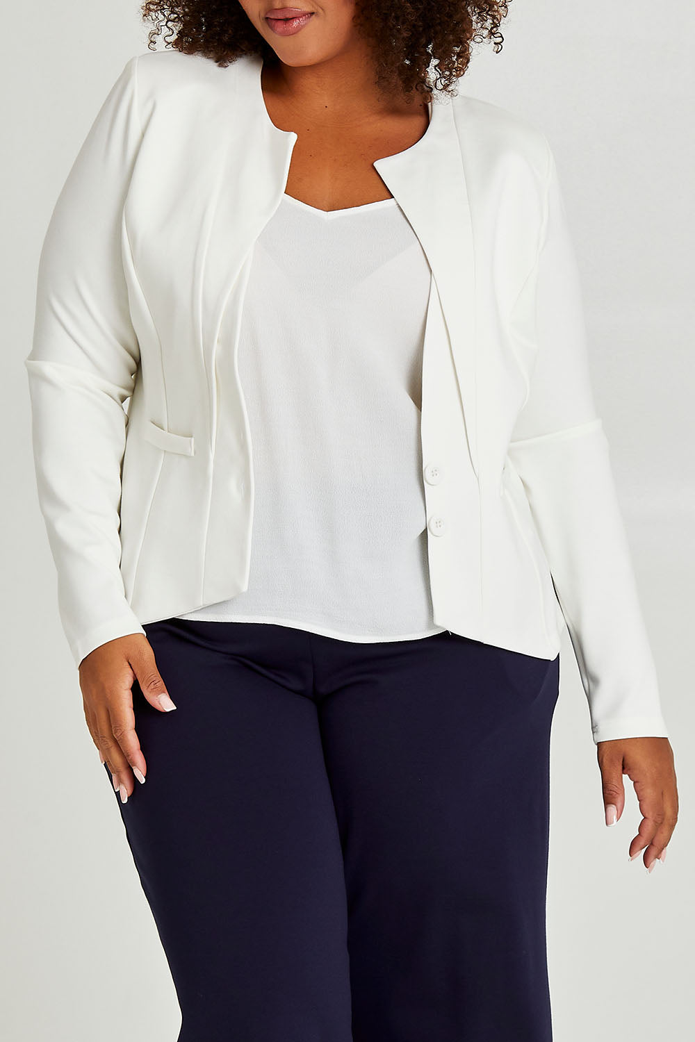 Model Alexis wearing size 16 of The Define Ponte Jacket in colour Ivory (White), from the front, cropped image