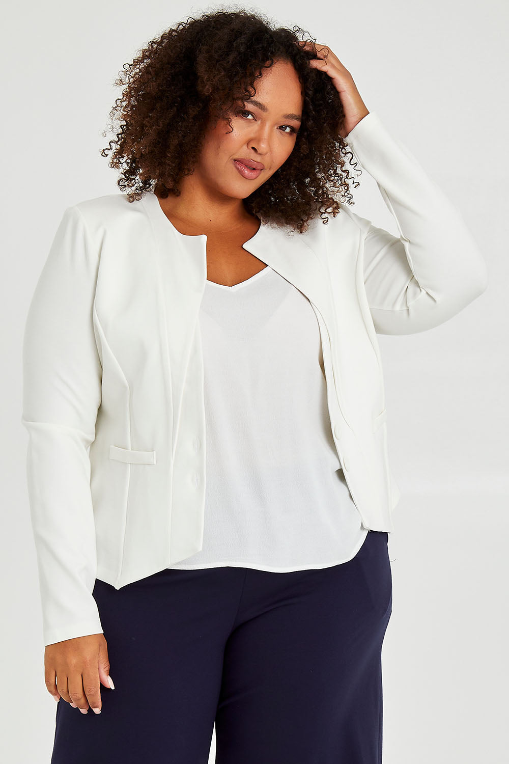 Model Alexis wearing size 16 of The Define Ponte Jacket in colour Ivory (White), from the front, cropped image
