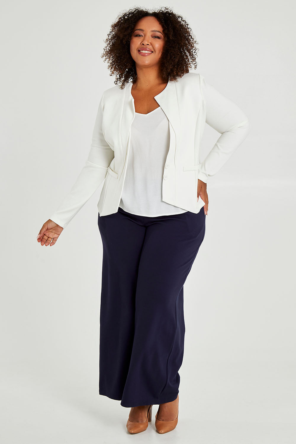 Model Alexis wearing size 16 of The Define Ponte Jacket in colour Ivory (White), from the front, showing the whole outfit