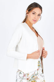 Model Madeline wearing size 10 of The Define Ponte Jacket in colour Ivory (White), from the front, cropped image