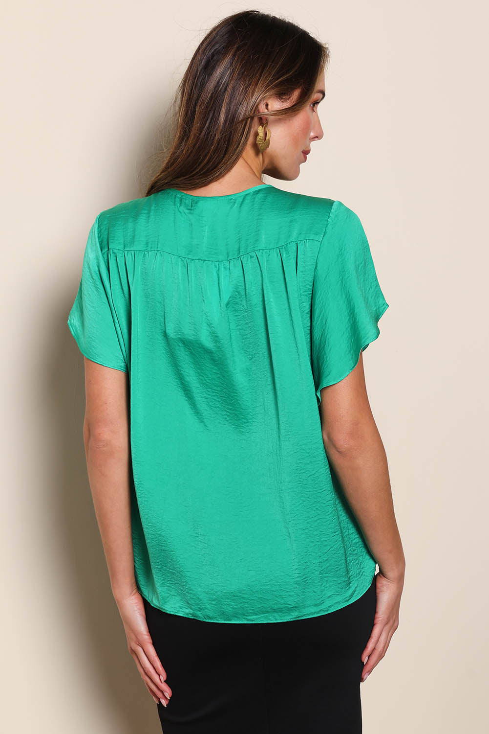 Model Madelinec wearing size 10 of the The Shirred Detail Top - Green in colour Green, from the back