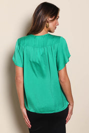 Model Madelinec wearing size 10 of the The Shirred Detail Top - Green in colour Green, from the back