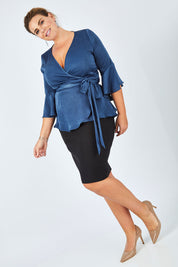Model Fiona wearing size 16 of The Luxe Wrap Top in colour Opal (Blue), from the front, showing the whole outfit