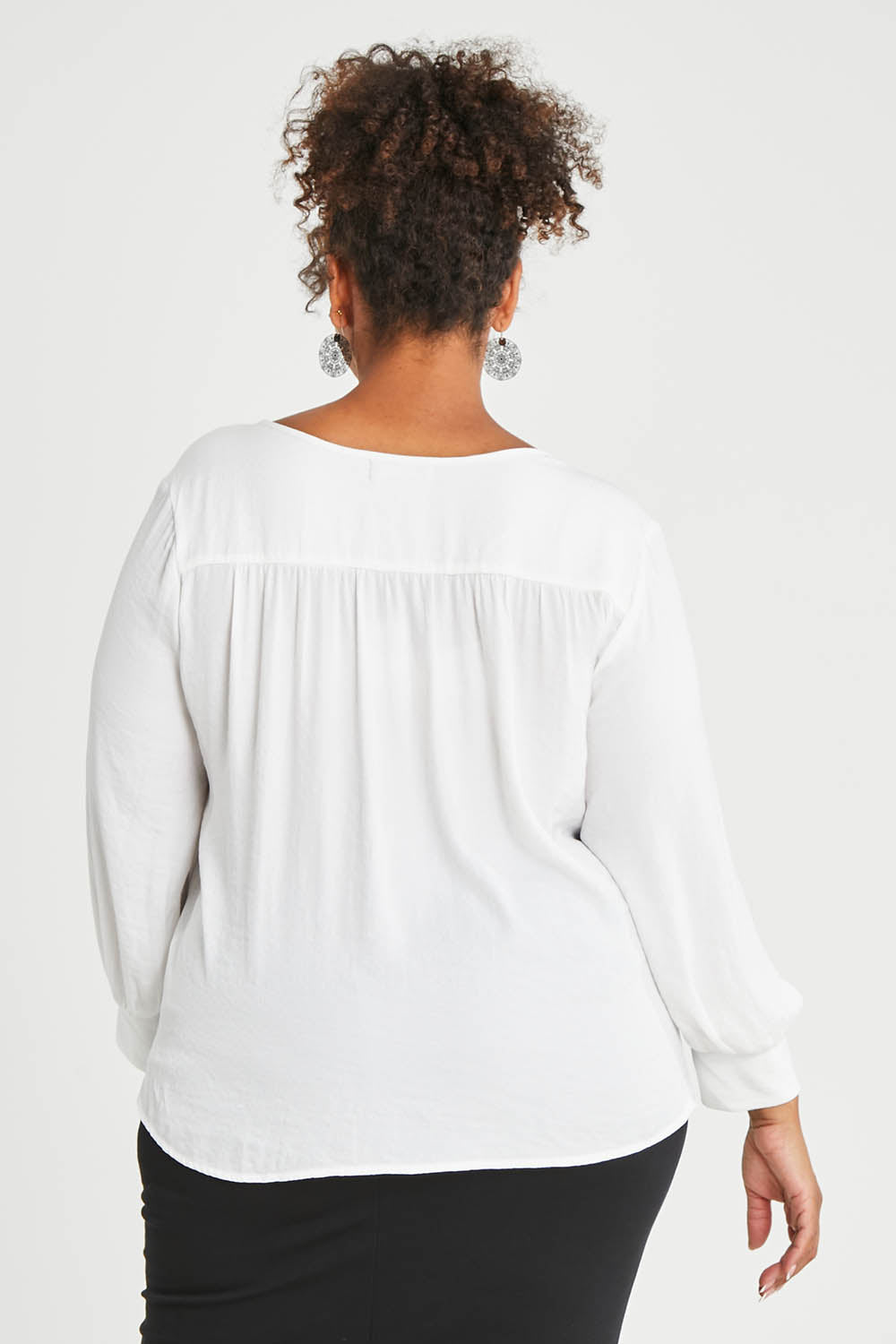 Model Alexis wearing size 16 of The Luxe Dobby Blouse in colour White (White), from the back