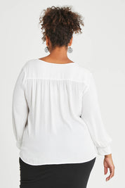 Model Alexis wearing size 16 of The Luxe Dobby Blouse in colour White (White), from the back
