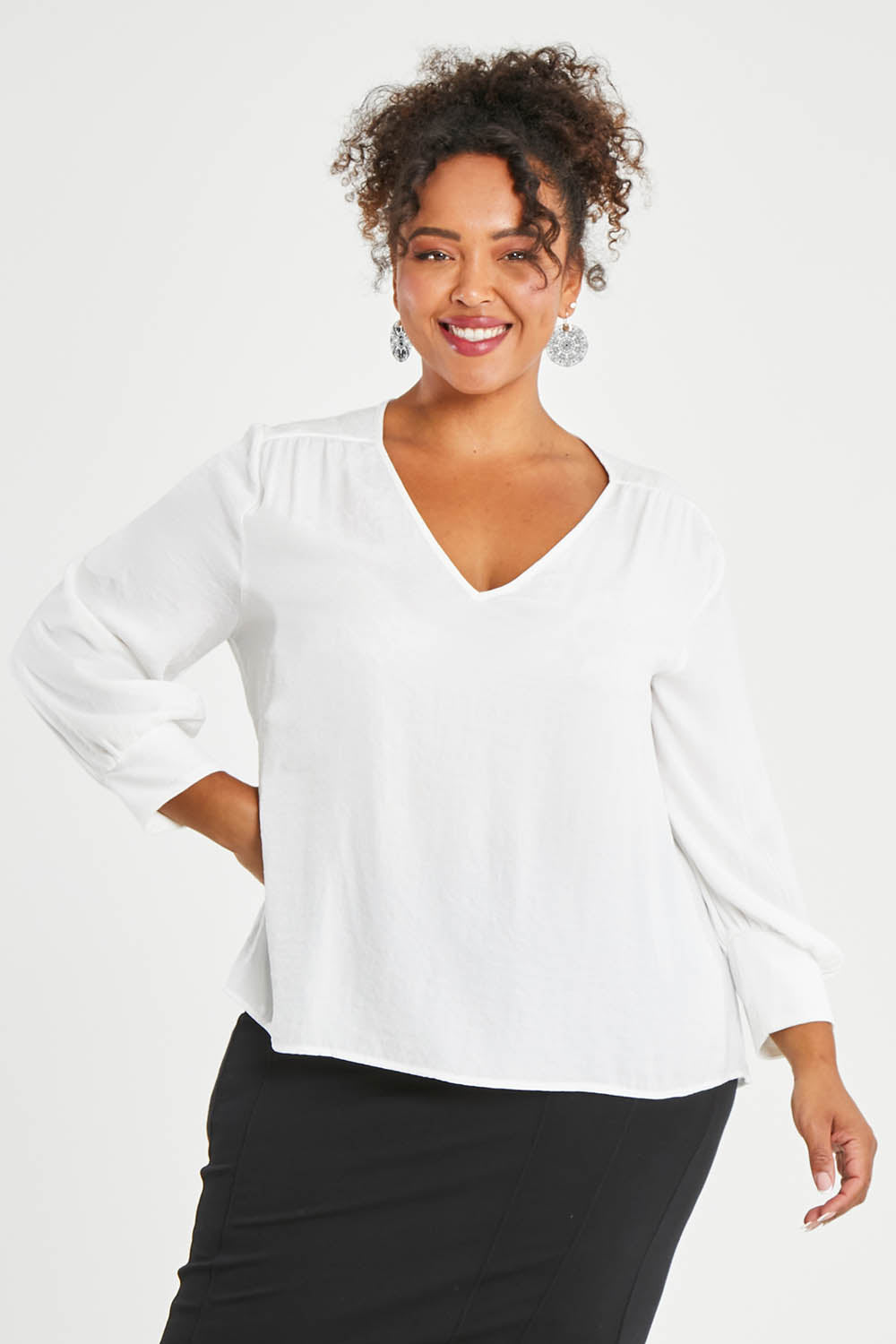 Model Alexis wearing size 16 of The Luxe Dobby Blouse in colour White (White), from the front, cropped image