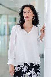 Model Miranda wearing size 10 of The Luxe Dobby Blouse in colour White (White), from the front, showing the whole outfit