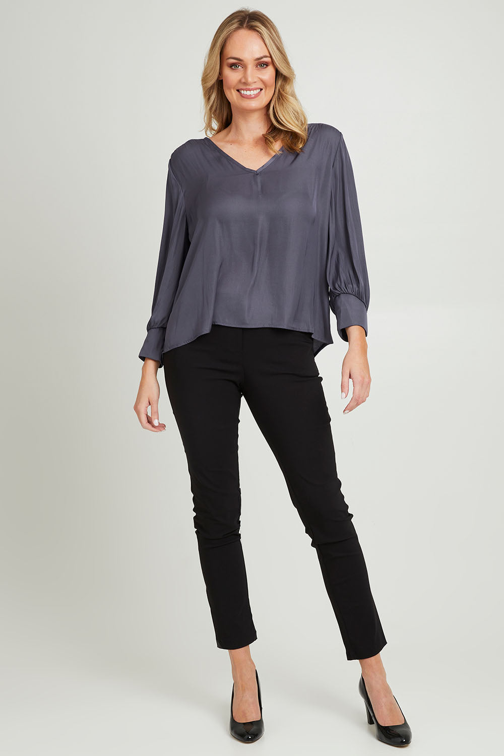 Model Grace wearing size 10 of The Luxe V Neck Blouse in colour Slate (Grey), from the front, showing the whole outfit