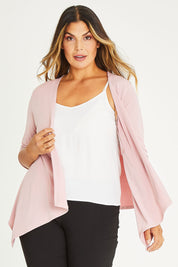 Model Palatina wearing size 16 of The Drape Cardi in colour Blushpink (Pink), from the front, cropped image