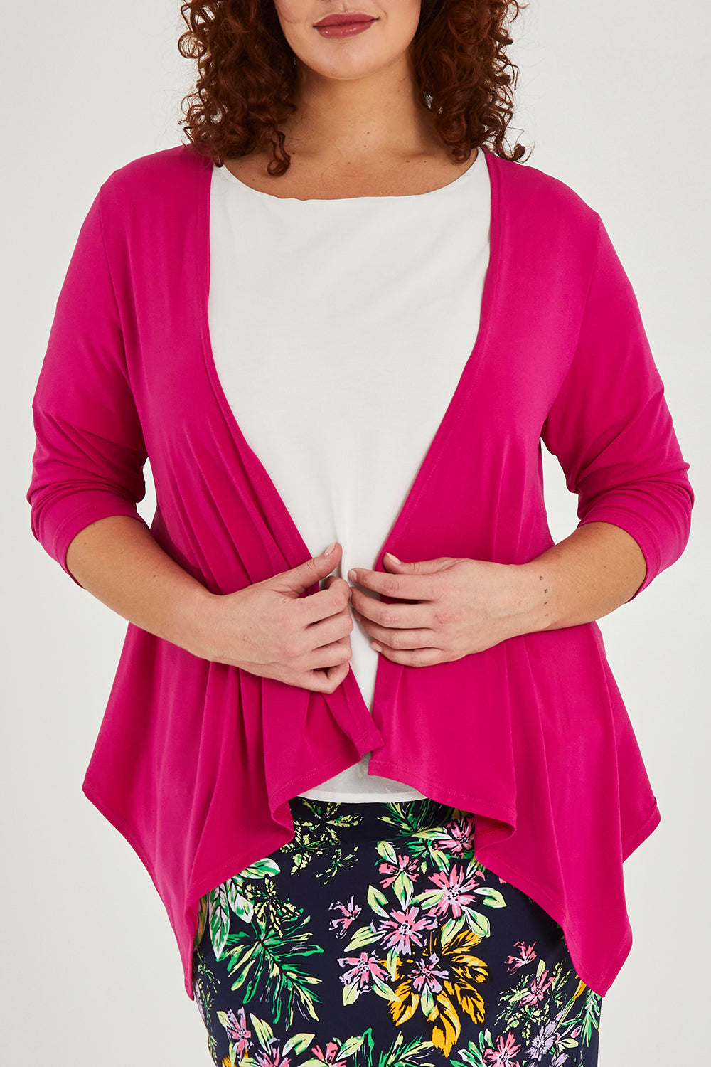 Model Maddy wearing size 16 of The Drape Cardi in colour Hotpink (Pink), from the front, cropped image