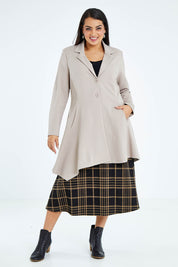 Model Sasha-Lee wearing size 16 of The Asymmetrical Hem Coat in colour String, from the front, showing the whole outfit