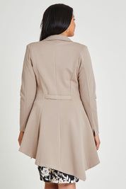 Model Terri-Leigh wearing size 14 of The Asymmetrical Hem Coat in colour String, from the back