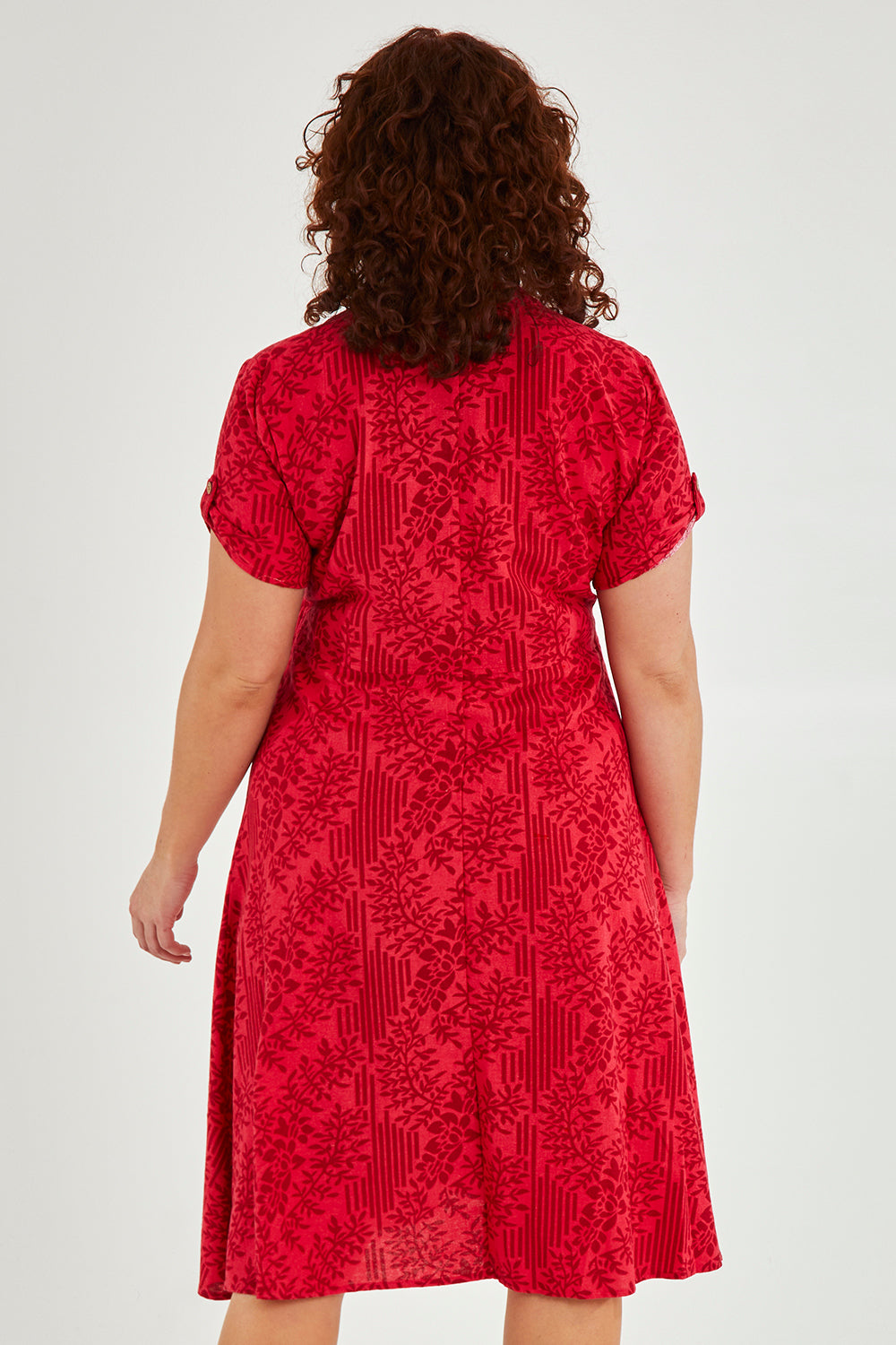 Model Maddy wearing size 16 of The Printed Cotton V Neck Dress in colour Bamboo (Red), from the back