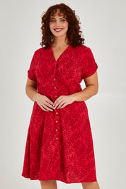 Model Maddy wearing size 16 of The Printed Cotton V Neck Dress in colour Bamboo (Red), from the front, cropped image