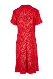 Product shot of The Printed Cotton V Neck Dress in colour Bamboo (Red), from the back