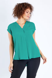 Model Lala wearing size 10 of The Essential Top in colour Jade (Green), from the front, cropped image