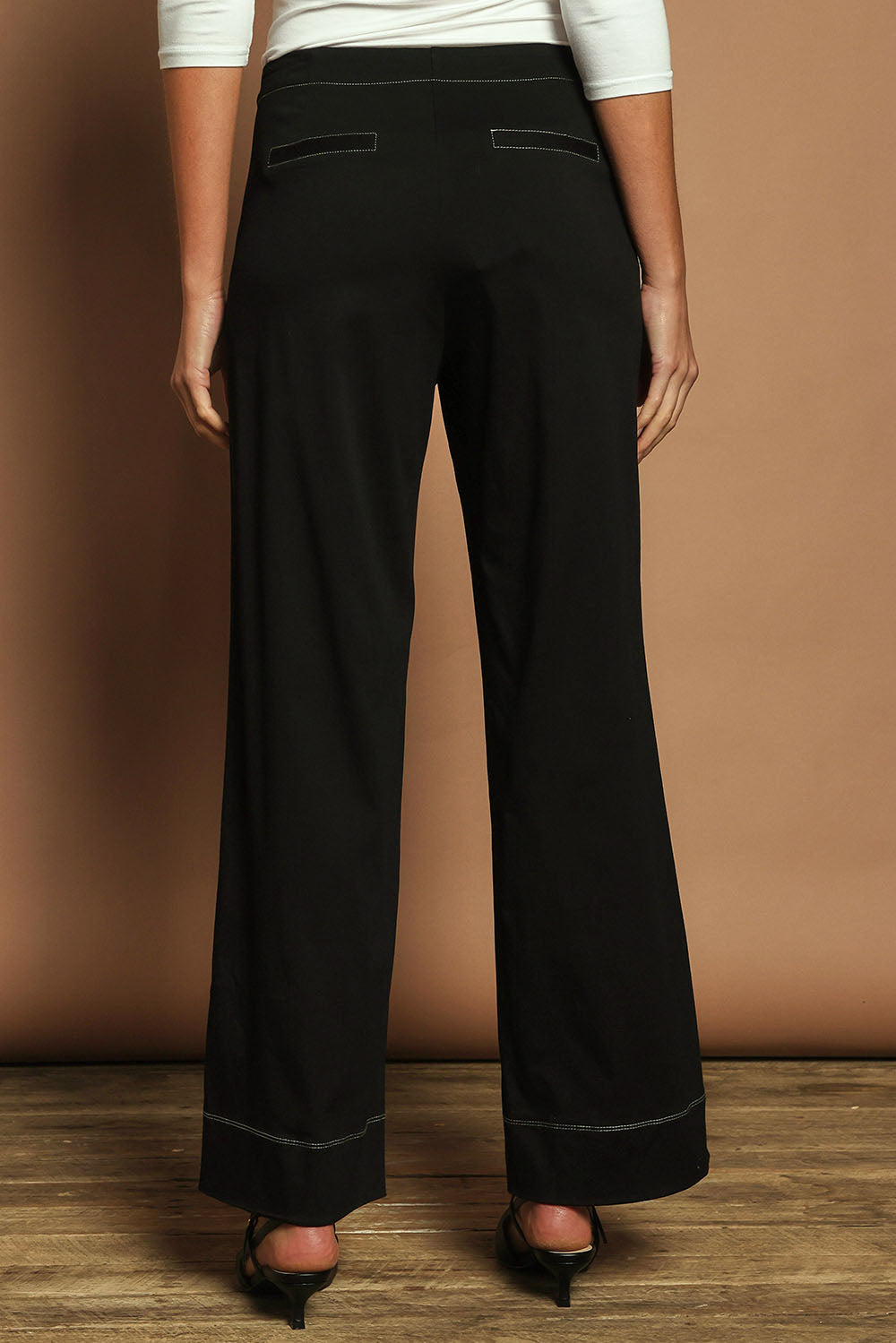 Model Madeline wearing size 10 of The Contrast Stitching Stretch Pant in colour Black (Black), from the back