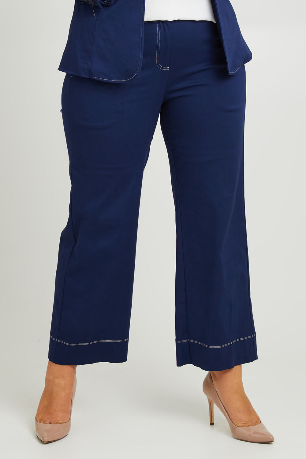Model Fiona wearing size 16 of The Contrast Stitching Stretch Pant in colour Navy (Blue), from the front, cropped image