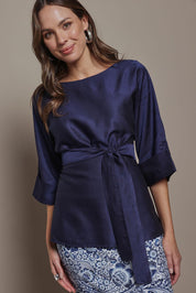 Model Madeline wearing size 10 of The Luxe Dolman Sleeve Blouse in colour Darkcobalt (Blue), from the front, cropped image