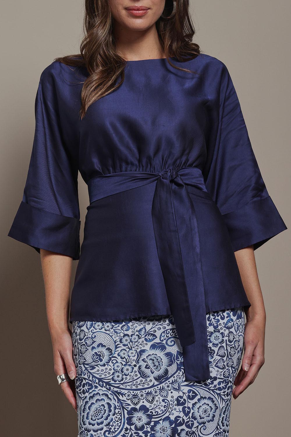 Model Madeline wearing size 10 of The Luxe Dolman Sleeve Blouse in colour Darkcobalt (Blue), from the front, cropped image