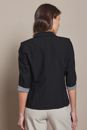 Model Madeline wearing size 10 of The Contrast Inner Cuff Blazer in colour Black (Black), from the back