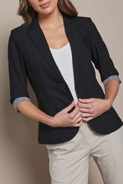 Model Madeline wearing size 10 of The Contrast Inner Cuff Blazer in colour Black (Black), from the front, cropped image