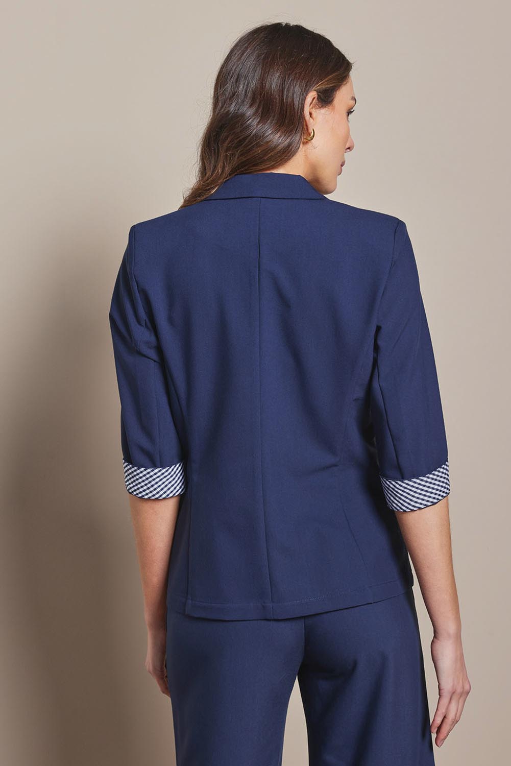 Model Madeline wearing size 10 of The Contrast Inner Cuff Blazer in colour Navy (Blue), from the back