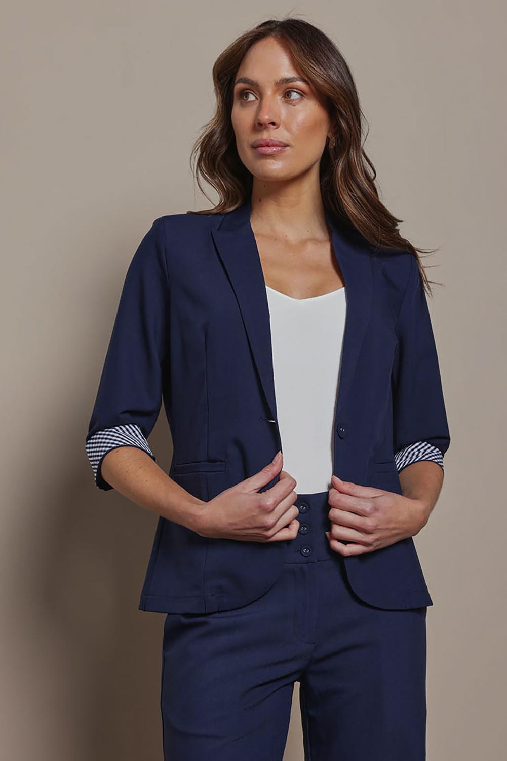 Model Madeline wearing size 10 of The Contrast Inner Cuff Blazer in colour Navy (Blue), from the front, cropped image
