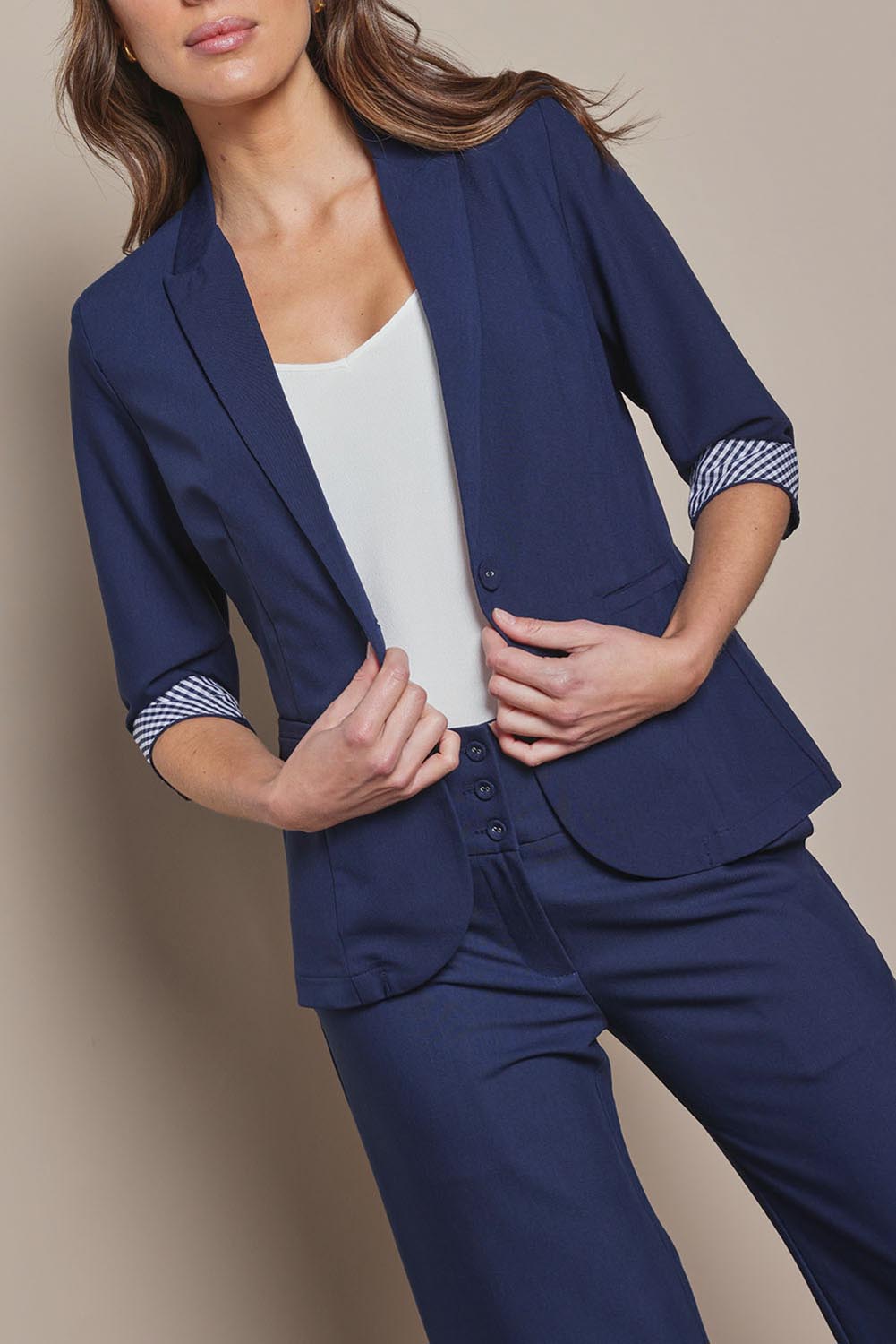 Model Madeline wearing size 10 of The Contrast Inner Cuff Blazer in colour Navy (Blue), from the front, cropped image