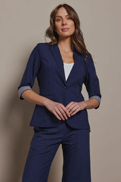 Model Madeline wearing size 10 of The Contrast Inner Cuff Blazer in colour Navy (Blue), from the front, cropped image