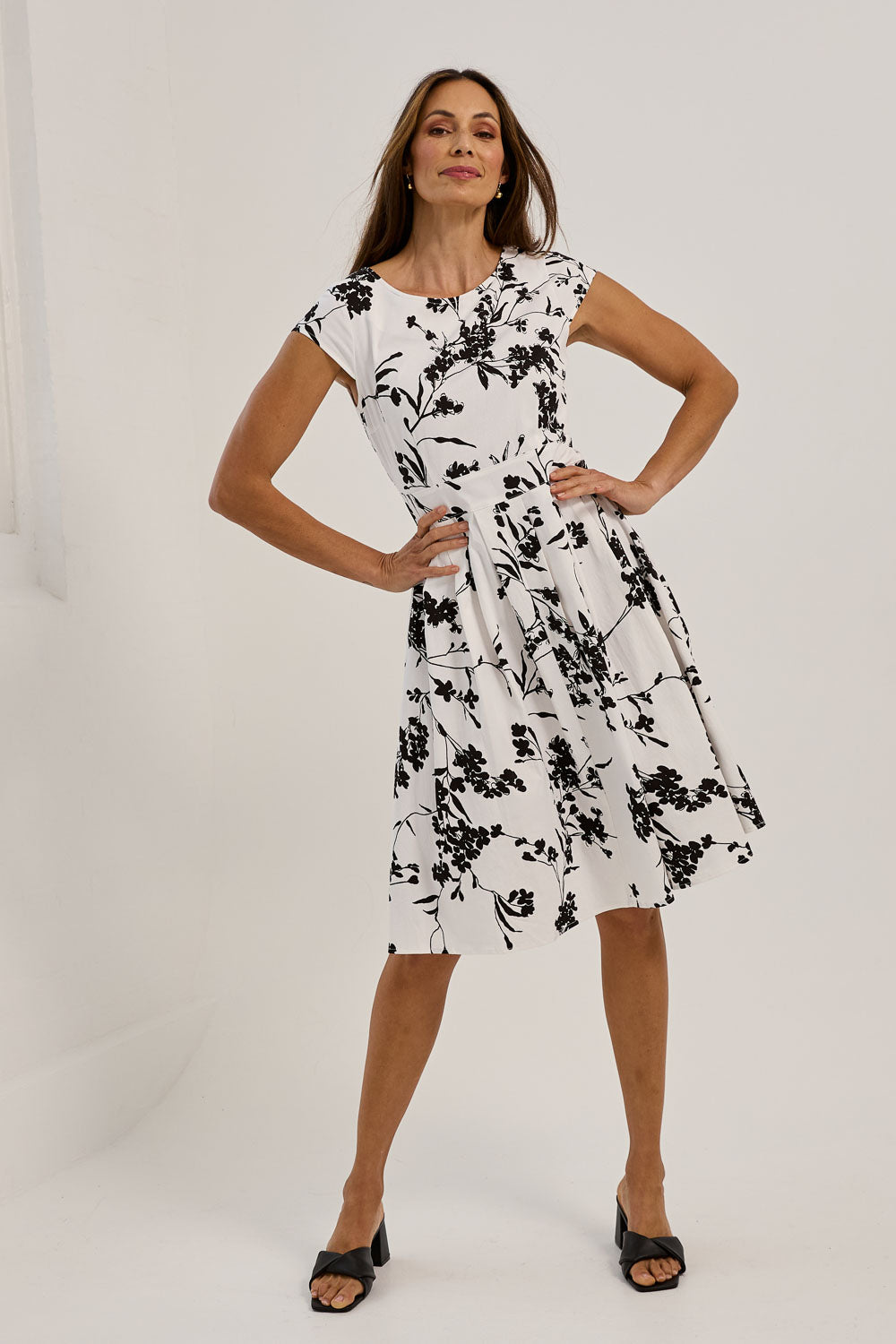 Model Amanda wearing size 10 of The Pleated Cotton Stretch Dress in colour Monofleur (White), from the front, showing the whole outfit