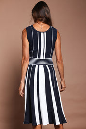 Model Amanda wearing size S of The Reversible Knit Dress in colour Navystripe (Blue), from the back
