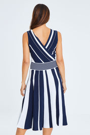 Model Cara wearing size S of The Reversible Knit Dress in colour Navystripe (Blue), from the back